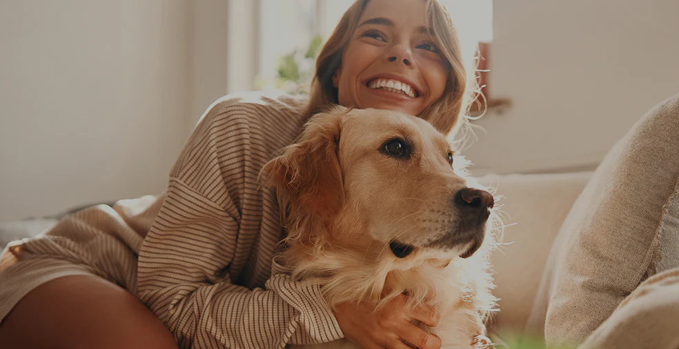 Woman cuddling with dog